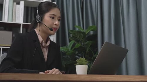 Young Woman in Business Meeting on Laptop