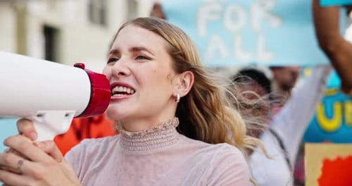 Adults Protesting with Megaphone in City