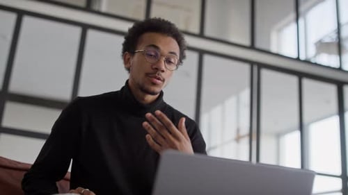 Man Speaking During a Video Call Using Laptop in Office