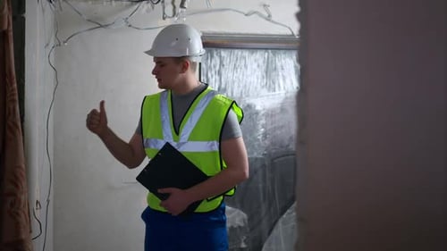 Construction Worker in Hardhat Explaining Renovation Plan