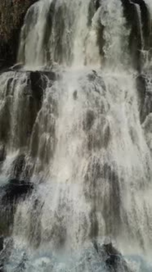Aerial view of waterfall cascading down, Iceland.