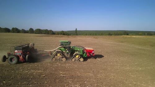 Tractor on the field seeding wheat
