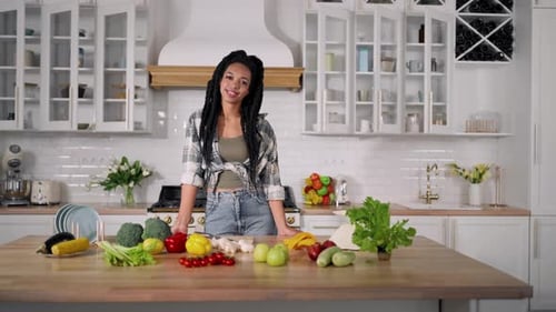 Smiling Woman in Modern Kitchen with Fresh Produce