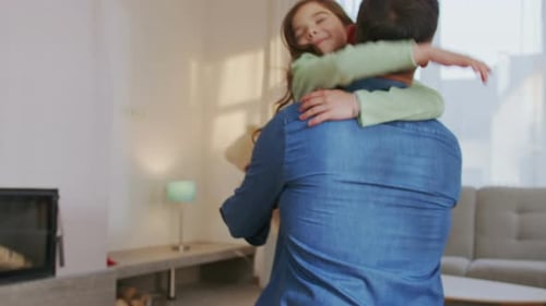 Father and Daughter Embrace in a Cozy Living Room
