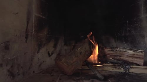 Cozy rustic fireplace with burning wood and glowing embers. Homey atmosphere. Argentina.