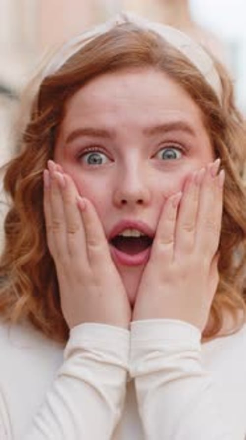 Redhead Woman Looking Surprised at Camera Shocked By Sudden Win Good Victory News Wow in City Street