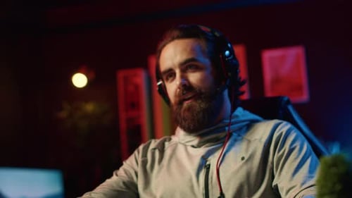 Man Gaming in a Dark Room with Headphones