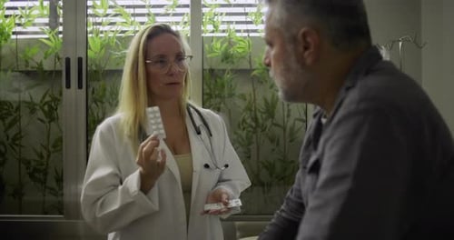 Woman Doctor Explaining Pills to a Male Patient