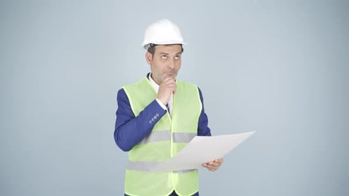 The engineer watching the construction is thoughtful.