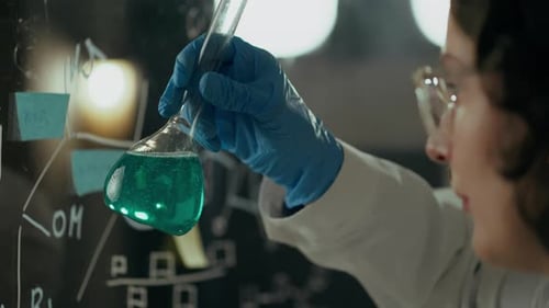 Biology, a microbiology doctor conducts a fluid test in a laboratory In research center. Experienced