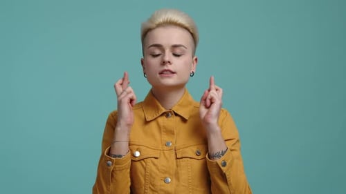 Young Adult with Crossed Fingers for Good Luck