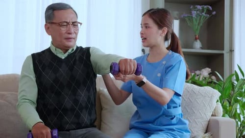 Senior Man Exercising with Healthcare Worker at Home