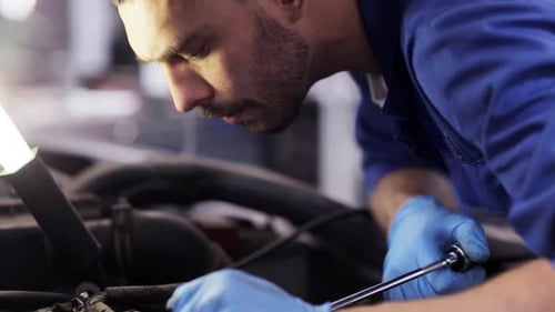 Car Service, Repair, Maintenance and People Concept - Mechanic Man with Wrench