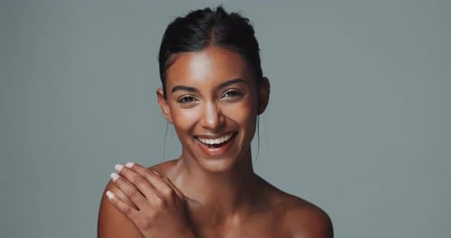 Face, makeup and skincare of happy Indian woman in studio isolated on gray background