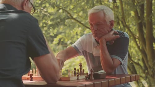 Old Men Playing Chess Outdoors