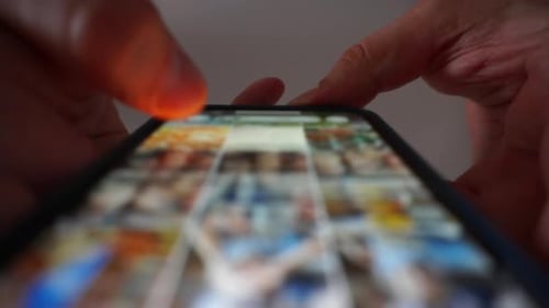 Finger Swiping on Smartphone Screen in Close-Up