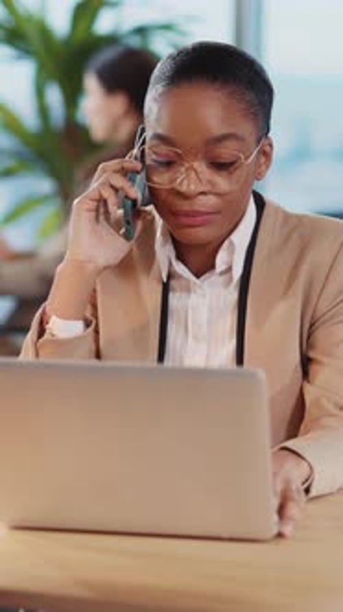 Black Young Professional Woman Working at the Office Talking Mobile Phone Business Conversation with