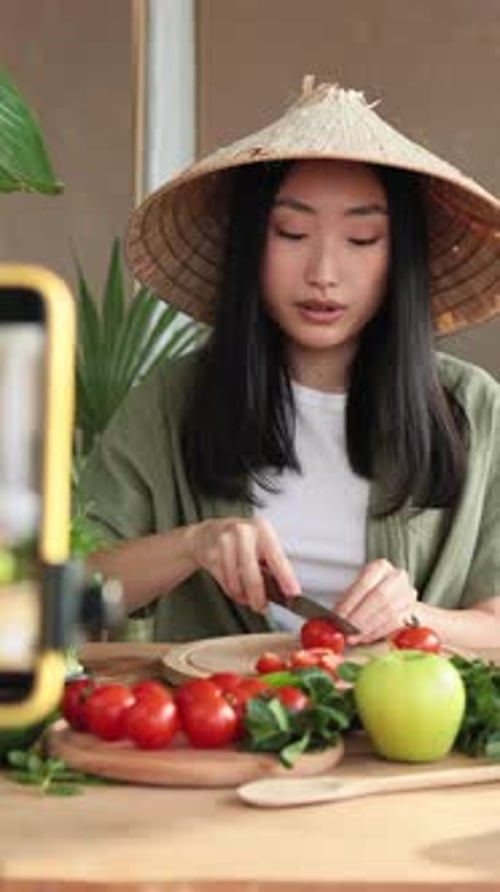 Woman in Conical Hat Cuts Tomatoes for Video