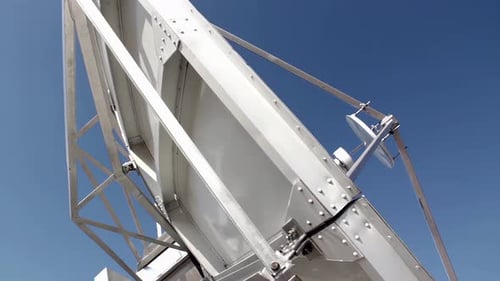 Satellite Dish Against Clear Blue Sky at Television Station. 4K.
