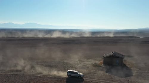 Cinematic tracking and revealing drone shot of cars traveling along the Charyn Canyon, Kazakhstan