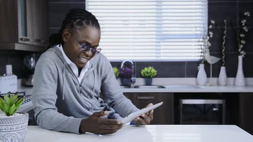 Man Using Tablet Device in Modern Kitchen Setting