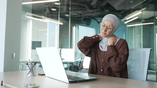 Woman in Office Experiencing Neck Pain