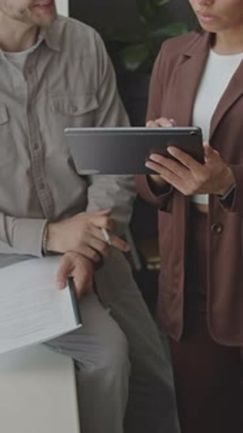Professionals Collaborating Using a Tablet in Office