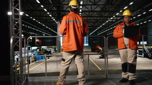 Diverse Team of Employees Monitoring Production and Welding Activity
