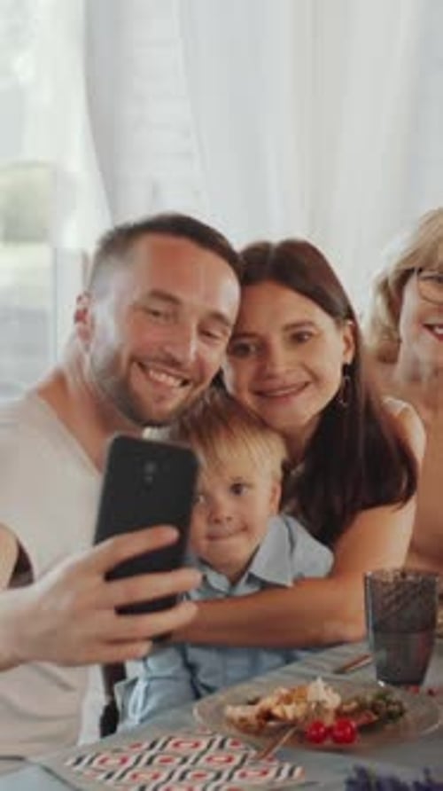 Smiling Family Poses for Selfie at Birthday Party