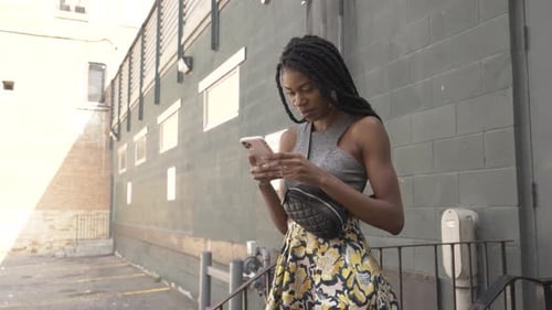 Beautiful Stylish Woman Using Smart Phone in City Alley Adult