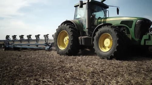 Tractors plowing the field in Ukraine