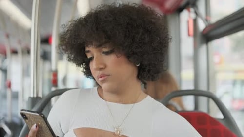 Young Adult Using Smartphone on Public Transit