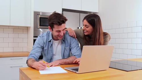 Happy Couple Planning Together in Modern Kitchen