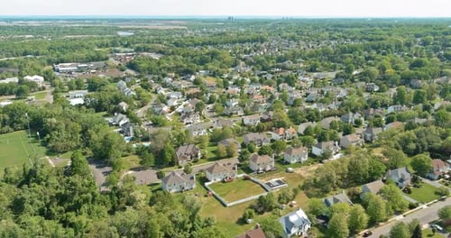 Expansive View of a Suburban Neighborhood Showcasing Residential Homes and Green Spaces
