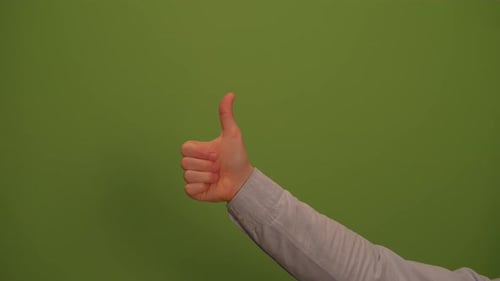 A Thumbs Up Gesture Set Against a Vibrant Green Background That Radiates Positivity and Joy