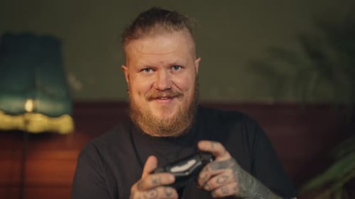 Man with Beard Playing Video Game Indoors