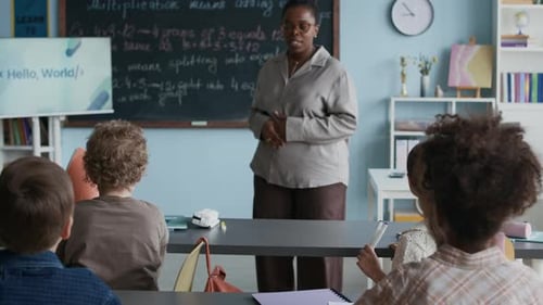 Teacher Teaches Math to Elementary Students in Classroom