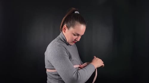 Woman Measures Her Bust with Measuring Tape