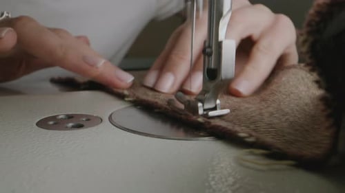 Seamstress Works on Sewing Machine in Atelier