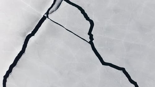 Drone Flight Over Intricate Pattern of Cracks on the Icy Surface of Frozen Lake