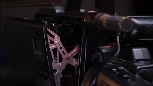 Hand Inserting VHS Tape Into Video Camera