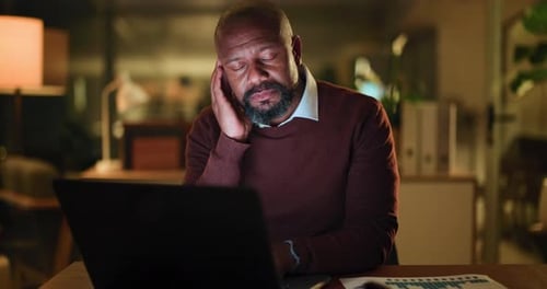Night, laptop and black man in office with headache, burnout or overtime fatigue in finance