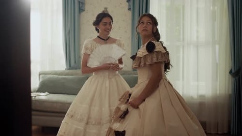 Women in Elegant Period Dresses Indoors Conversing