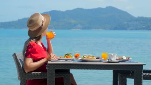 Vacation Girl in Luxury Resort Enjoys Morning Breakfast with Fresh
