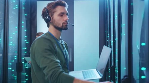 Tech Professionals Actively Monitor Systems Within a Robust Data Center Environment