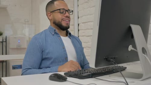 Man on Video Call at Computer in Office