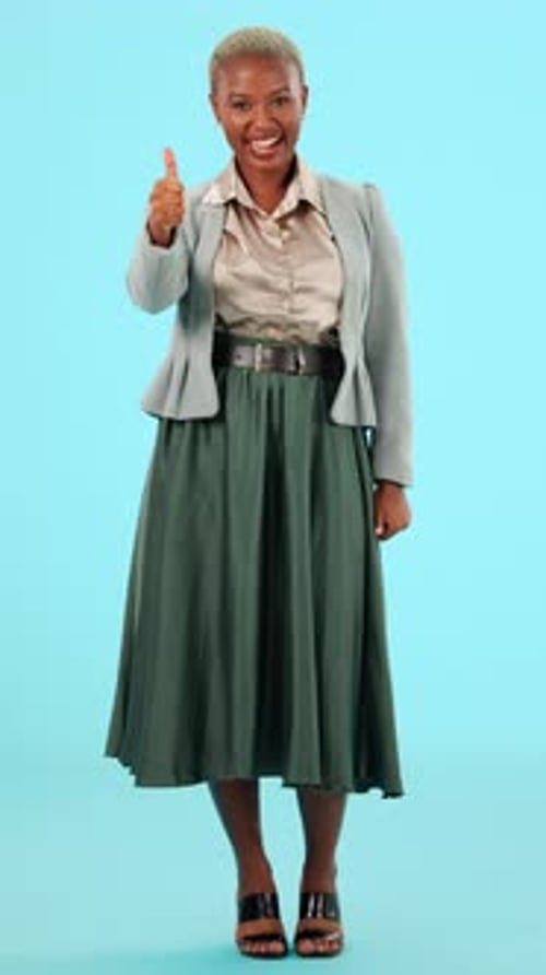 Thumbs up, business and black woman on blue background for yes, agreement and approval in studio