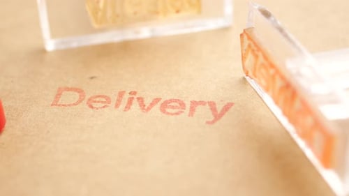 Delivery Stamps Creating Impressions on Brown Packaging Paper