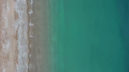 A drone flies over the transparent Adriatic Sea in Croatia. Beautiful azure water and coastline.