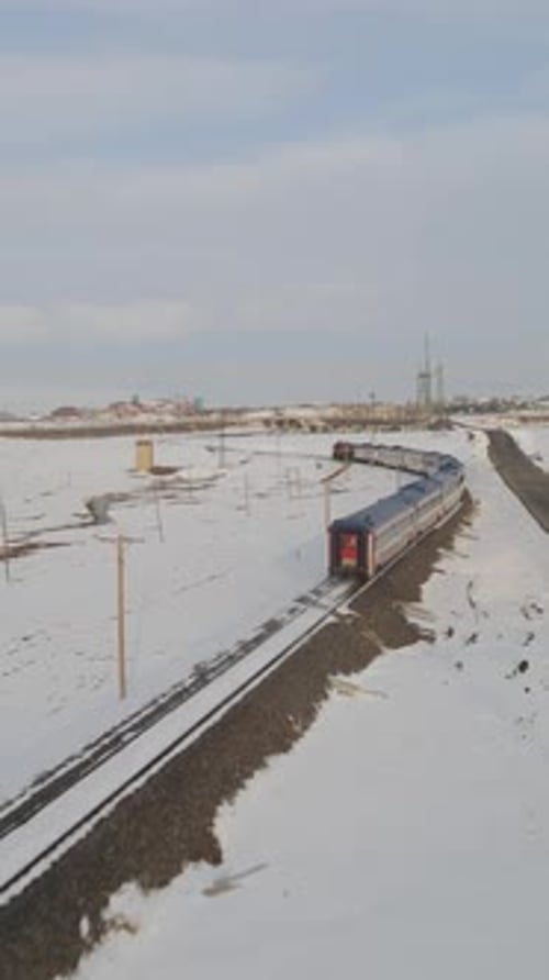 Train Travels Through Snow Covered Winter Landscape